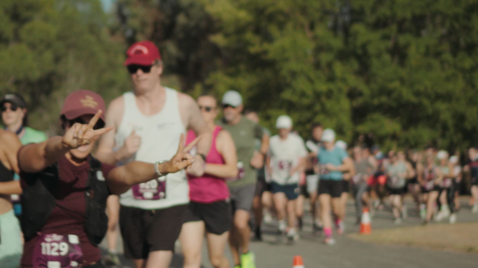 Runners on course giving peace signs